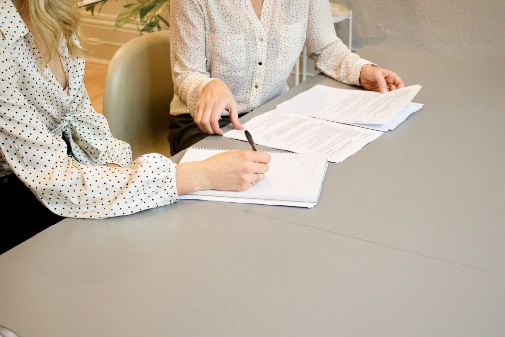 Two female coworkers reviewing papework