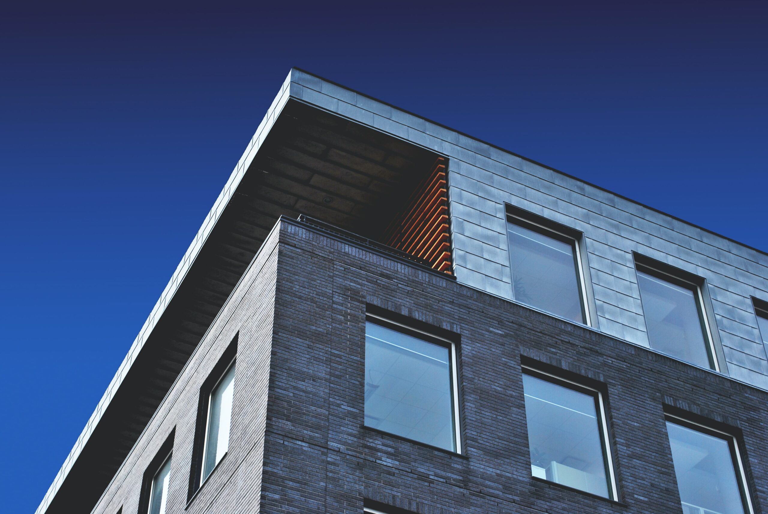 Concrete and brick building lines against dark blue sky